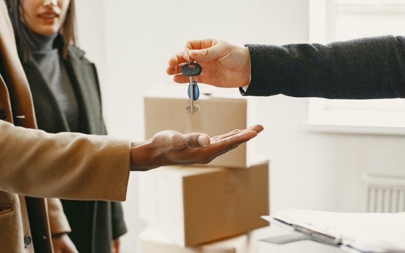 person giving keys from new home to family