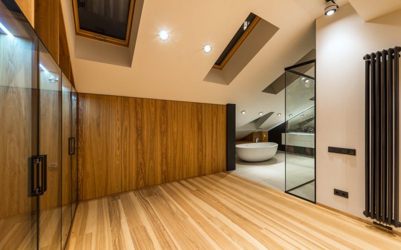 modern bathroom interior with glass wall in attic